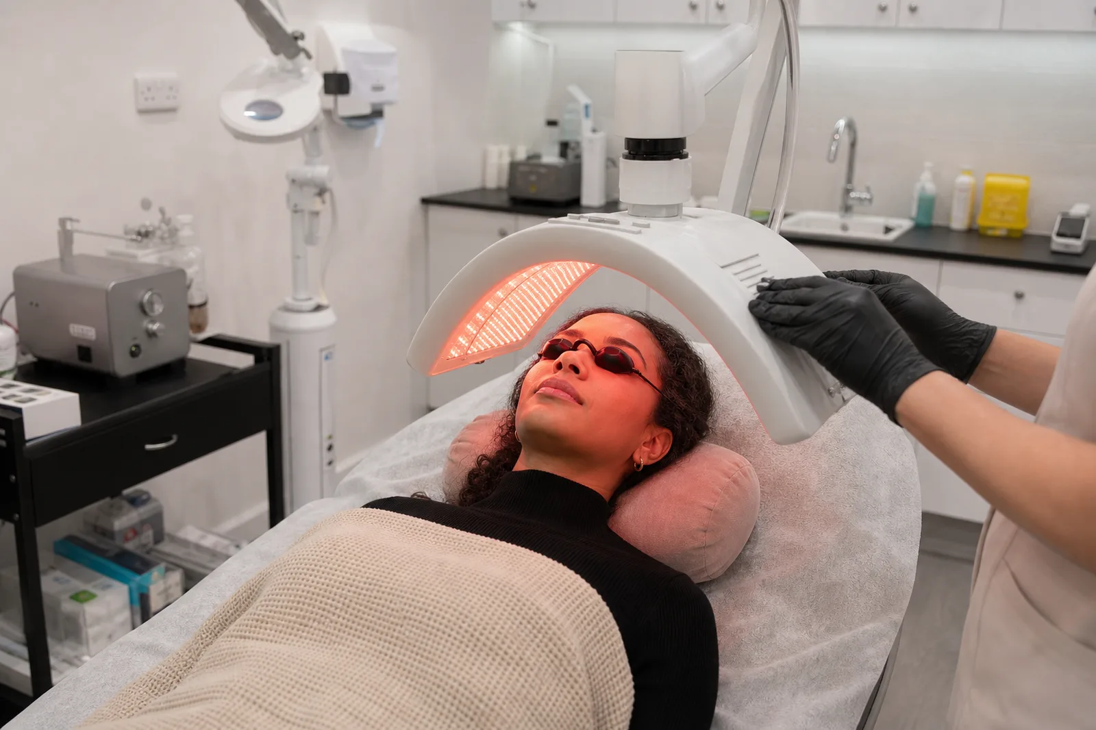 Client receiving red LED light therapy in the Beautique Artistry treatment room