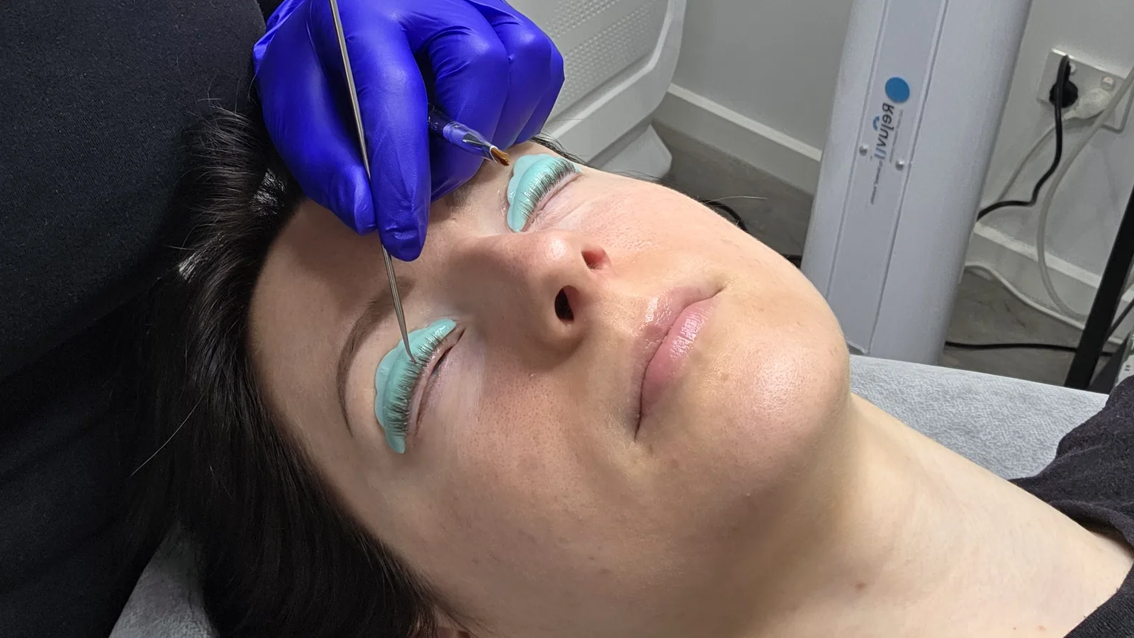 Client relaxing during a lash lift treatment at Beautique Artistry
